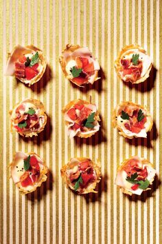 small appetizers are arranged on a striped tablecloth