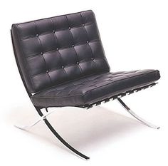 a black leather chair sitting on top of a metal frame