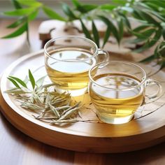 two cups of green tea on a wooden tray