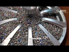 a machine that is making some kind of thing out of rocks and metal parts on it