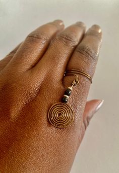 "Gold wire Spiral wrapped ring, with black beads.  Elegantly hand-crafted and lightweight. Designed to inspire \"The Zen in You!\" * 6 centimeter length. * 2 centimeter width. * Handcrafted with love. * Beautifully packaged. NOTE: Items in people's carts does not  mean they are unavailable for purchase. It's how Etsy (not the seller) alerts you  to make your purchase before anyone else buys it!" Wire Earrings Handmade, Wire Spiral, Copper And Pink, Wire Wrapped Ring, The Zen, Hand Bracelet, Wire Rings, Wire Wrapped Rings, Handmade Wire