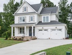 a large white house with two garages