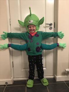 a little boy dressed up in a costume