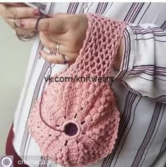 a woman wearing a pink knitted purse