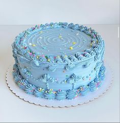 a blue frosted cake with sprinkles on it