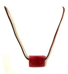 Organic Tagua Nut Rectangular Pendant * 21.5 Necklace Length Leather Stap * Organic Rectangular Pendant * Pendant Height: 23mm * Pendant Width: 4mm * Pendant Length: 32mm * Handmade in Ecuador This Product is handcrafted from a palm tree nut native to the lush tropical rainforests of Ecuador. Also referred to as the Ecuadorean Ivory Palm, the Tagua tree produces several bushels of seed pods a year with up to 100 Tagua nuts per pod. These nuts are then harvested, dried, and crafted into a wide ra Adjustable Minimalist Necklace With Rectangular Pendant, Handmade Adjustable Rectangular Necklace, Adjustable Necklace With Rectangular Pendant, Minimalist Adjustable Rectangular Necklace, Necklaces With Adjustable Chain And Square Pendant, Red Rectangular Adjustable Jewelry, Adjustable Rectangular Necklace With Lobster Clasp, Tagua Necklace, Ivory Necklace