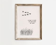 a framed print with birds flying in the sky