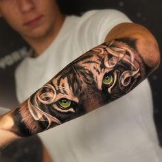 a man with a tiger tattoo on his arm