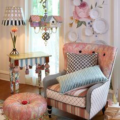 a living room filled with furniture and a chandelier hanging from the ceiling over a table