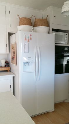 a white refrigerator freezer sitting inside of a kitchen