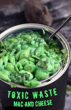 a can filled with green food sitting on top of a table