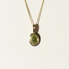 The peridot used for this necklace has a clear olive green hue that maintains it’s vibrant color even in dim lighting. This characteristic is why peridot is often referred to as evening emerald. The pendant is made in 18k gold and comes on an 18” curb chain made in solid 14k gold. Modern Yellow Gold Peridot Jewelry, Modern Gold Jewelry With Peridot, Modern Gold Peridot Jewelry, Oval Green Amethyst Jewelry In Yellow Gold, Elegant Green Birthstone Necklace In 14k Gold, Oval Green 14k Gold Necklace, Yellow Gold Polished Peridot Jewelry, Yellow Gold Peridot Jewelry With Polished Finish, Elegant Green Peridot Birthstone Necklace