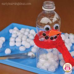 a glass bottle filled with white balls and a red stuffed animal