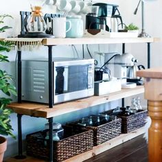 a coffee bar with various items on the shelves and plants in baskets next to it