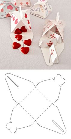 an origami box with hearts in it and cut out the paper to be used for valentine's day