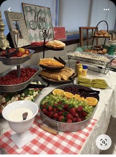 an assortment of fruits and pastries on a buffet table