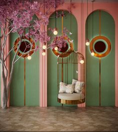 a birdcage filled with pink flowers sitting in front of a green and pink wall