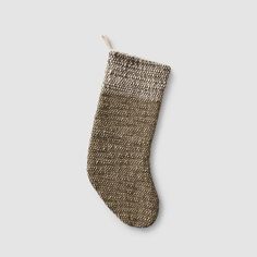 a christmas stocking hanging from the side on a gray background with a white string