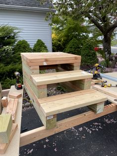 three wooden shelves stacked on top of each other in the middle of a backyard area