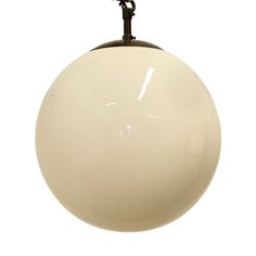 a large white ball hanging from a metal hook on a light fixture with a chain attached to it