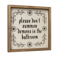 a framed sign that says, please don't summon demons in the bathroom