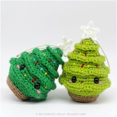 two crocheted christmas trees sitting next to each other