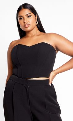 Seduce all evening long in the curve-loving stylings of our must-have Alexis Corset. Flaunting a crop hem and strapless bust, this gorgeous top ticks all the style boxes. Key Features Include: - Deep V neckline - Subtle structured boning - Stretch shirred back - Dropped front and crop back hemline - Fully lined - Back zip fastening - Crepe feel, slight stretch fabrication Wear with wide leg pants and strappy stilettos for an elevated party look. | Plus Size Corset Alexis 24 in Black, Size 18/M | City Chic Fitted Cropped Tube Top For Date Night, Corset Plus Size, Corset Shop, Plus Size Clothing Online, Plus Size Corset, Half Shirts, Strappy Stilettos, Party Look, Black Corset