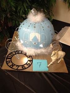 a table topped with a blue cake covered in white frosting and surrounded by other decorations