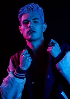 a young man is posing for a photo in the dark