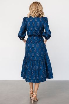 Your new favorite midi for any occasion Deep blue base that pulls topaz with blue and black floral print Cotton material has no stretch Notched V-neckline Functional loop buttons down bodice Mid-length sleeves with singular loop buttons at cuffs Adjustable drawstring waist Single-tiered midi skirt Lined bodice, unlined skirt and sleeves Self: 100% Cotton, Lining: 100% Polyester Fit runs big, we recommend sizing down Trina is 5'6, cup size 32D, size 2 and is wearing size XS Blue Floral Print Midi Dress For Work, Blue Floral Midi Dress For Work, Tiered Midi Skirt, Baltic Born, Mid Length Sleeves, Black Floral Print, Cup Size, Blue And Black, Favorite Dress