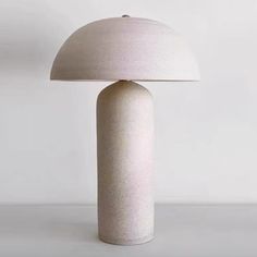 a white lamp sitting on top of a table