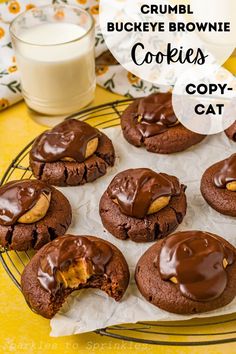 cookies with chocolate and peanut butter are on a cooling rack next to a glass of milk