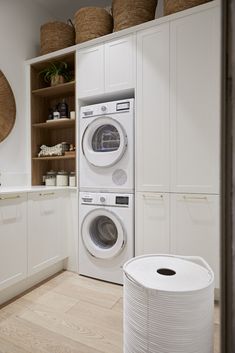 a washer and dryer in a white laundry room