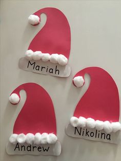 three santa hats with name tags on them