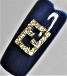 Fendi Gold Fashion Metal Alloy Nail Art Deco Nail decals. This fashion nail charm also has rhinestones on both of the letters. They are reusable and can be applied to natural or artificial nails. These decals can also be used to dress up other objects and other items. They are very easy to apply and can be done by a nail tech or even yourself. This is a great way to make yourself have a unique look all your own. Fendi Nails, Nail Charm, Art Deco Nails, Nail Charms, Artificial Nails, Nail Decals, Gold Fashion, Nail Tech, Fashion Nails