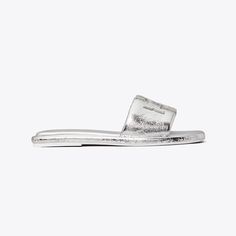 The classic sport slide, streamlined and refined. A trim band, padded in crinkled metallic leather. A slim cushioned sole for comfort and flexibility. Finished with a Double T, topstitched and oversized for a subtle statement. Luxury Slides With Textured Footbed For Spring, Casual Silver Leather Slides, Silver Leather Slides With Cushioned Footbed, Silver Casual Slides With Cushioned Footbed, Casual Silver Slides With Cushioned Footbed, Jelly Slides, Beautiful Sandals, Silver Shoes, Footwear Design Women