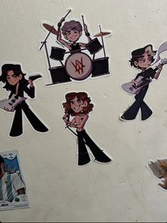 stickers on the back of a refrigerator with various pictures of people playing drums and singing