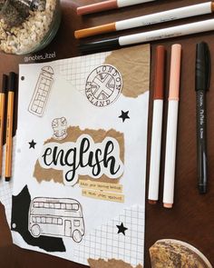 an open notebook with the word english written on it next to pencils and other items