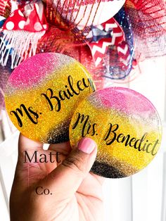 two personalized rocks with the words mr and mrs benedict on them are held up in front of a door