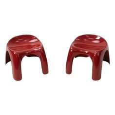 two red plastic stools sitting side by side