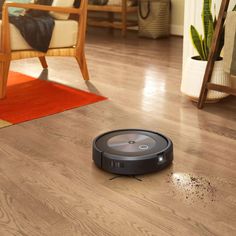 a roomba is on the floor with dirt all over it