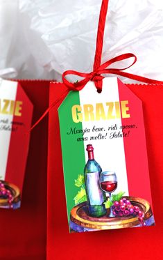 two red bags with wine tags attached to them