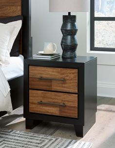 a night stand with two drawers and a lamp on the end table next to it