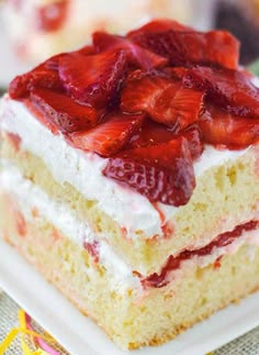 strawberry shortcake cake with whipped cream and fresh strawberries on top, ready to be eaten