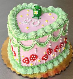 a cake decorated with pink and green frosting