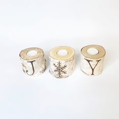 Spread a little holiday Joy this Christmas season with these adorable birch candle holders. Each birch log candle is hand burned with letters and a snow flake to show your JOY and holiday spirit. INCLUDES: Three birch candle holders that are 3-4" tall and 2.5-4" wide. Each log is drilled to hold a standard tea light candle and even includes 3 white tea light candles. MATERIALS: Each candle holder is made of real birch wood from Northern Maine that has been fireproofed and hand burned with the le Birch Bark Candle Holders, Birch Bark Candles, Birch Candle Holders, Birch Candles, Northern Maine, Log Candles, Birch Logs, Holiday Candle, Holiday Ribbon