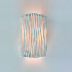 a wall light that is mounted to the side of a wall with wavy lines on it