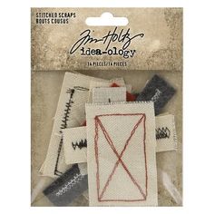 an assortment of stitchs and appliques in white packaging with red lines on them