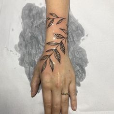 a woman's hand with a tattoo on it