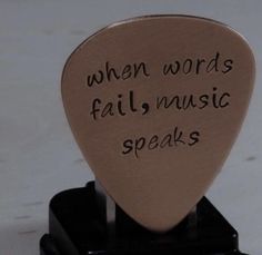 a guitar pick that says when words fail music speaks